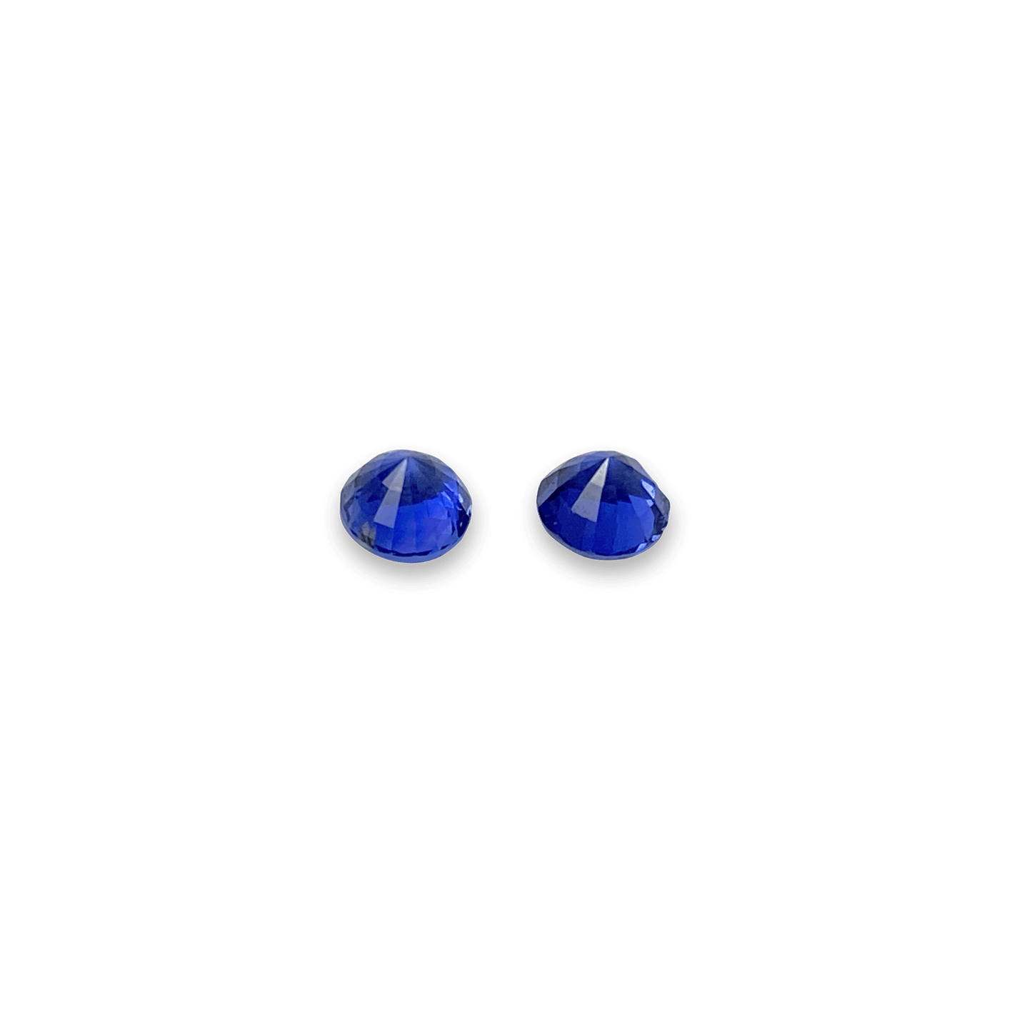 Elegant blue sapphire pair showcasing vibrant, deep blue hues with brilliant faceting, perfect for fine jewellery or gemstone collections.